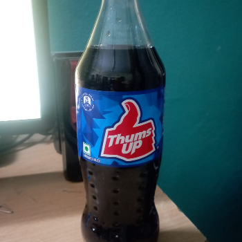 Thumsup 500 ml bottle displayed at a grocery store in Hyderabad