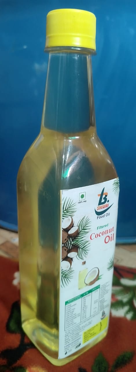 Pure Coconut Oil 500ml bottle displayed with natural elements in Indore