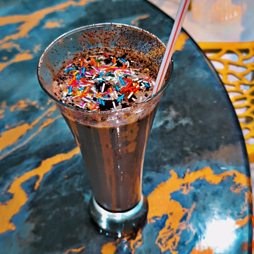 Delicious Hot Chocolate Shake in Bhatgaon served in a tall glass, topped with whipped cream and chocolate drizzle