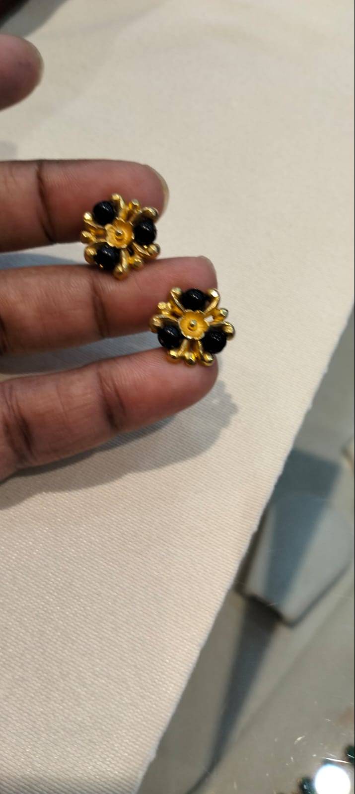 Elegant Black and Gold Stud Earrings in Davanagere