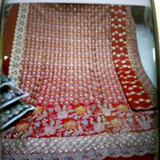 Elegant Sari draped stylishly, showcasing intricate patterns and rich fabric, available at SHIKHA CREATION in Surat.
