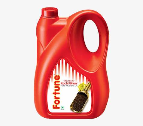 Fortune Mustard Oil 5L bottle with a vibrant label showcasing its purity and quality, placed on a wooden kitchen surface in S