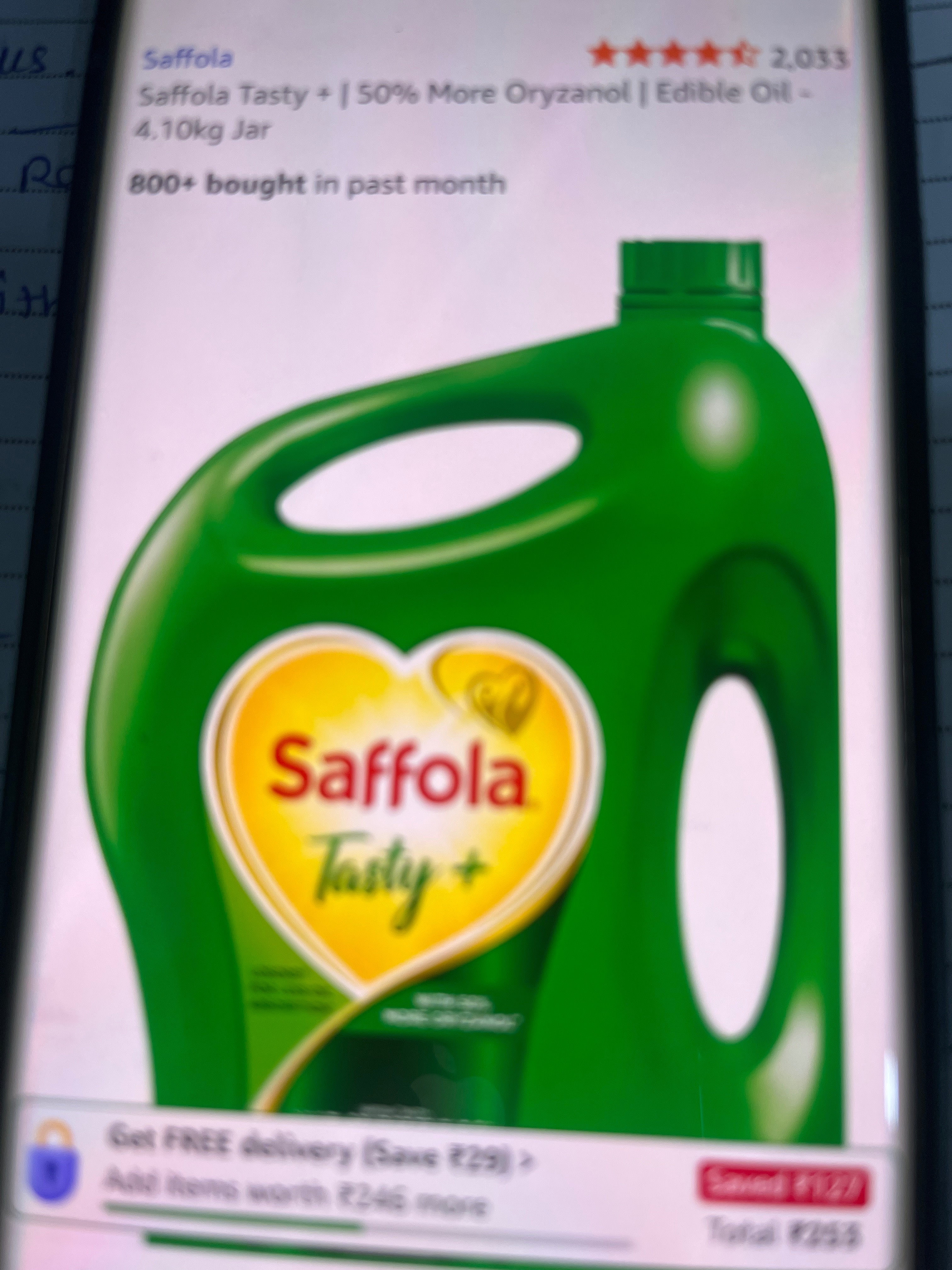 Saffola Tasty+ Edible Oil bottle with a vibrant label showcasing its health benefits, placed against a rustic kitchen backgro