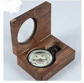 Vintage brass compass in a wooden box displayed elegantly, showcasing intricate details and craftsmanship from Nobel Handicra
