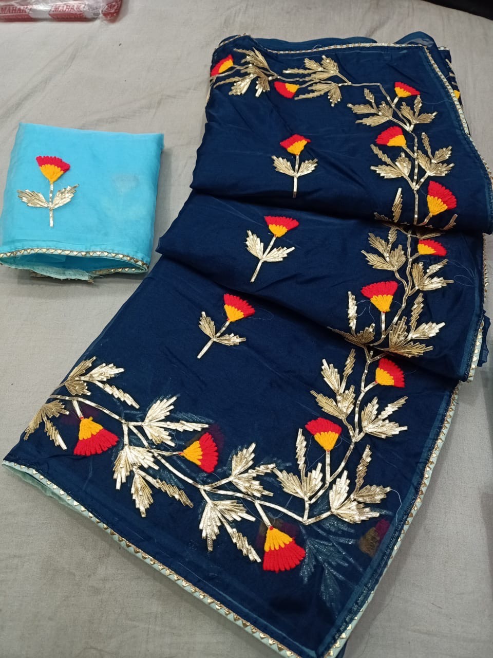 Elegant navy blue embroidered saree with vibrant floral design, perfect for festive occasions — Embroidered Navy Blue Saree i