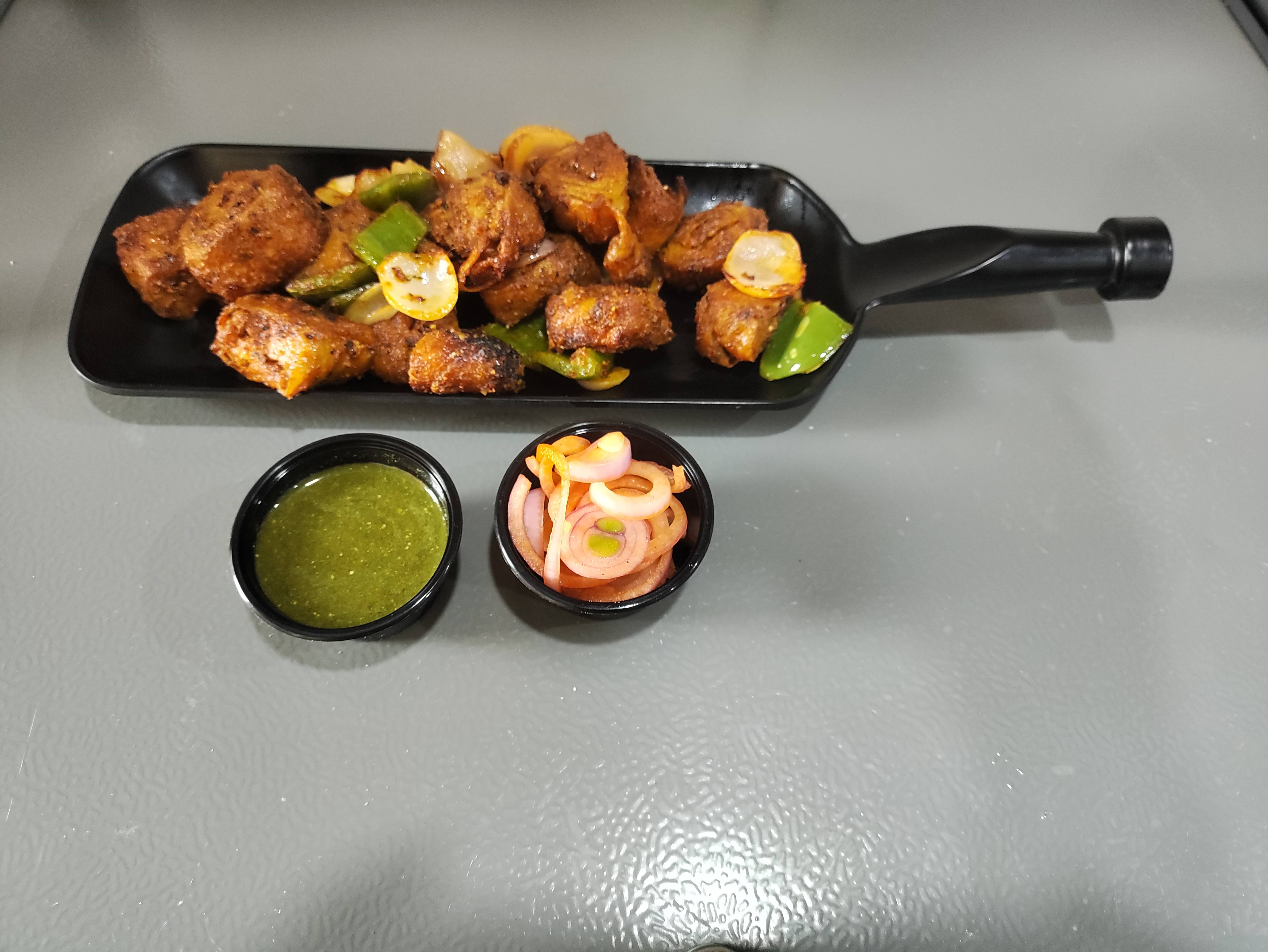 Crispy Soya Chaap served on a plate, showcasing its golden-brown texture, garnished with fresh herbs, from BIKANA RESTRO in B - Image 1