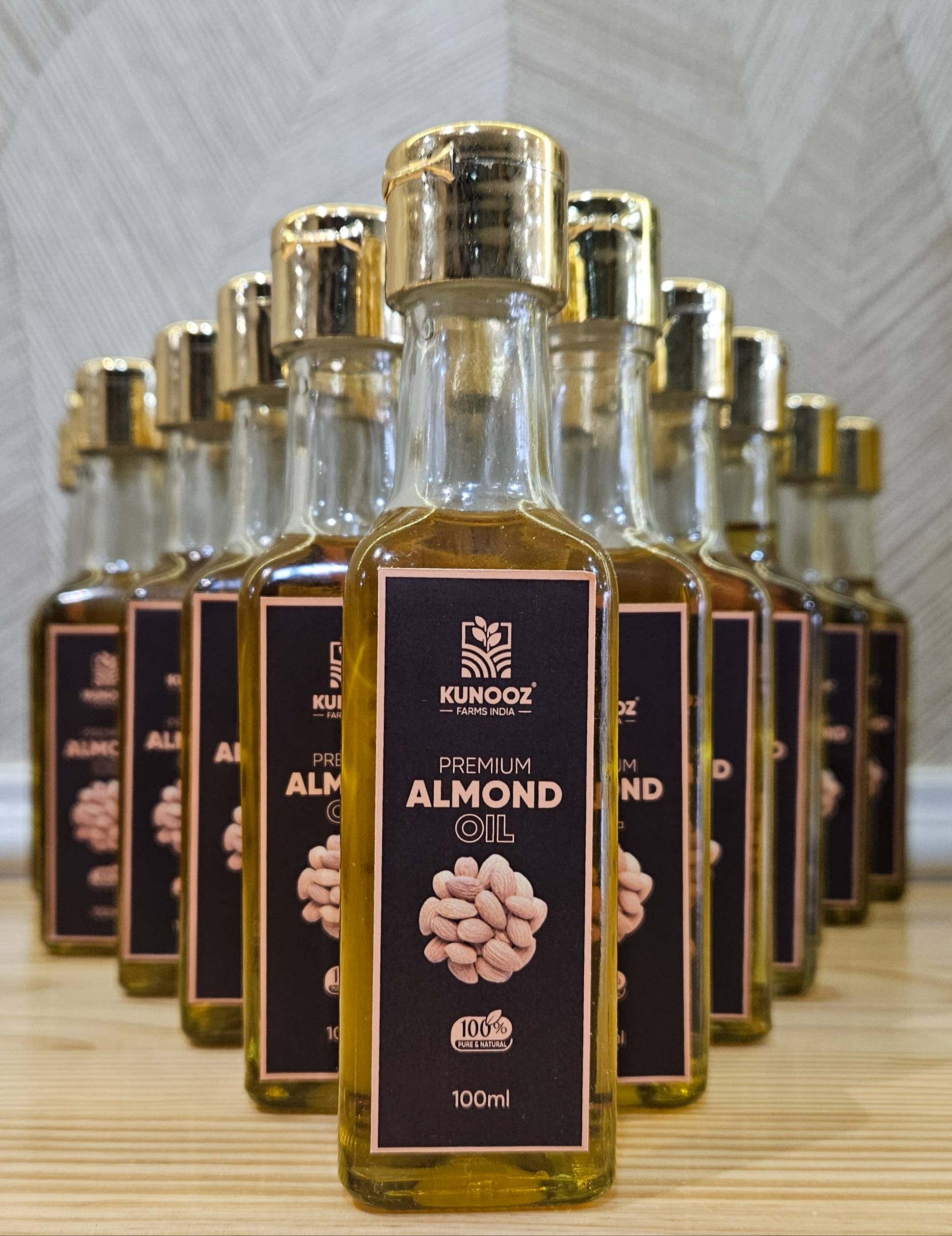 KUNOOZ Almond Oil bottle with a sleek design, showcasing its purity and premium quality, set against a neutral background in 