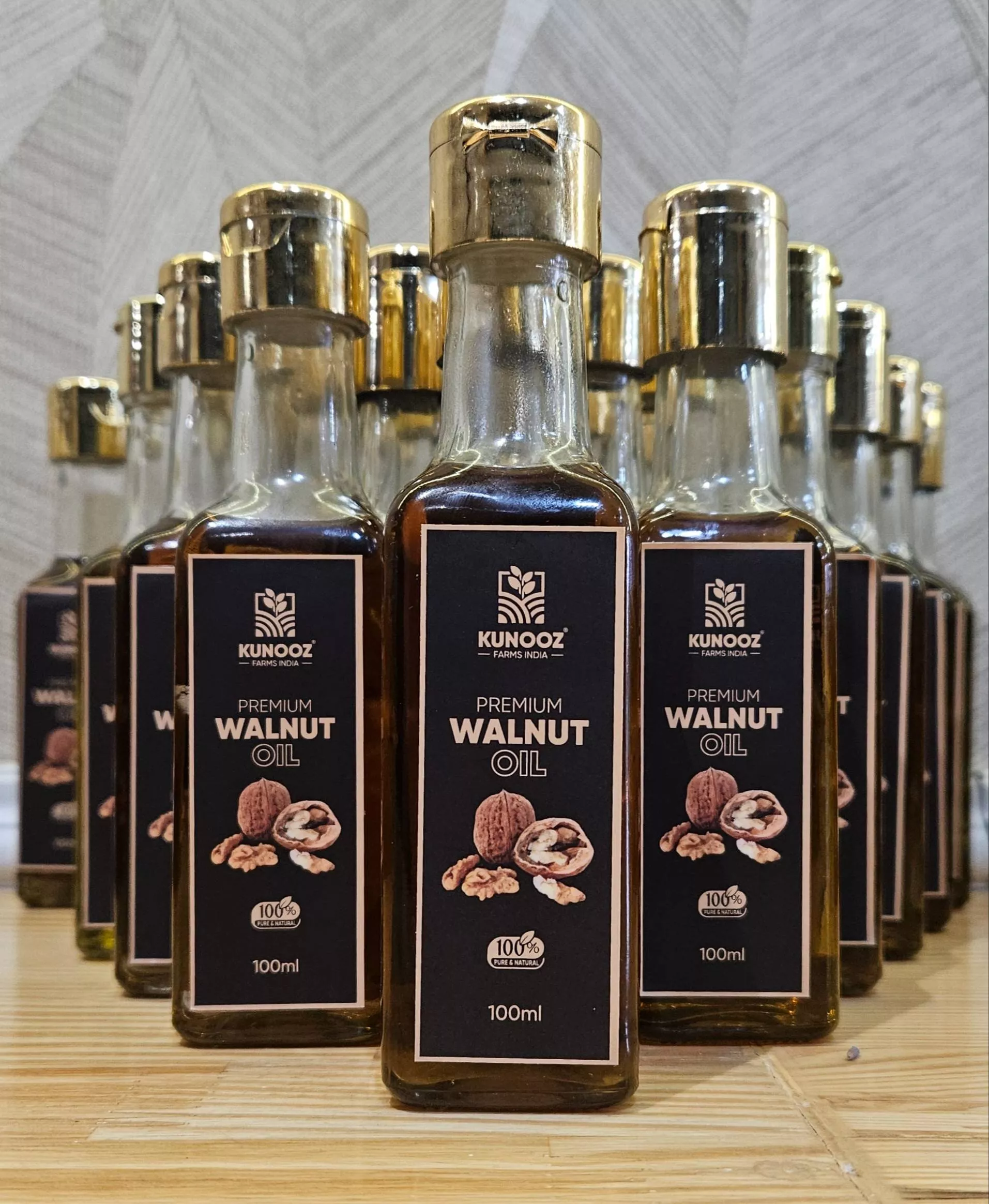 Bottles of KunoOz Premium Walnut Oil showcasing rich golden color, perfect for cooking and skincare, from Hyderabad