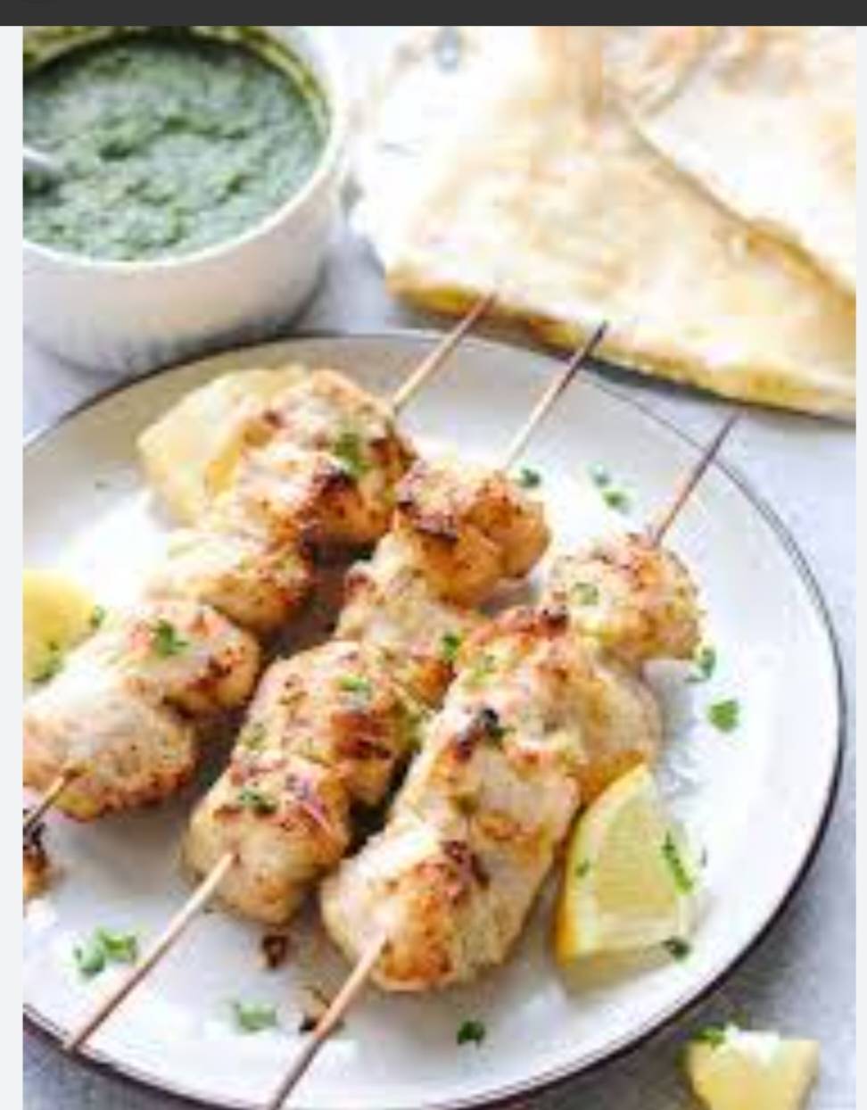 Delicious Paneer Malai Tikka featuring marinated paneer cubes grilled to perfection, served in a creamy sauce, located in Deh