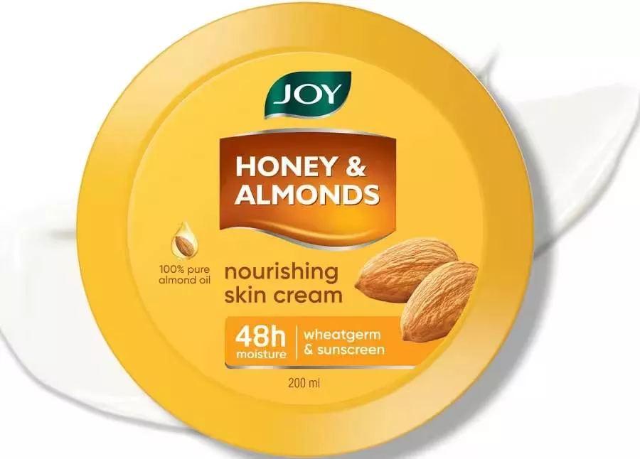 Joy Honey & Almonds Nourishing Skin Cream in a jar, showcasing a creamy texture, ideal for intense moisturization, located in