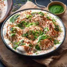 Delicious Dahi Vada from Brindavan Restaurant featuring crispy lentil fritters topped with creamy yogurt and tangy tamarind c