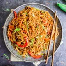 Brindavan Restaurant Instant Stir-Fried Noodles in Bidar served in a bowl, garnished with vegetables and spices, showcasing t