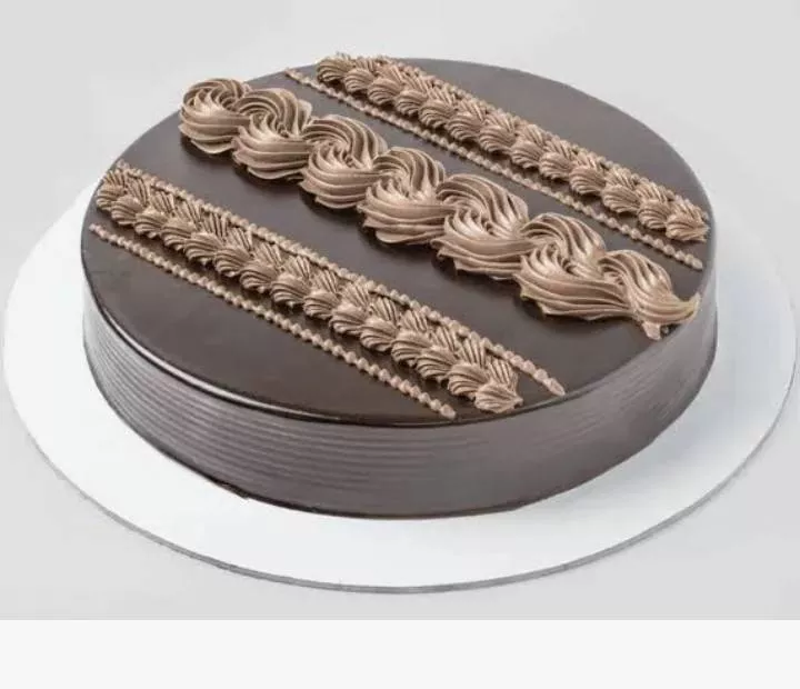 Delicious Cake from Monga Trading Company in Dabwali, beautifully decorated with icing, showcasing its rich texture and invit