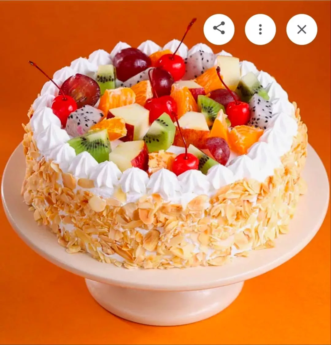 Fresh Fruit Topping Cream Cake features a light cream base adorned with colorful exotic fruits and crunchy almond flakes, ser