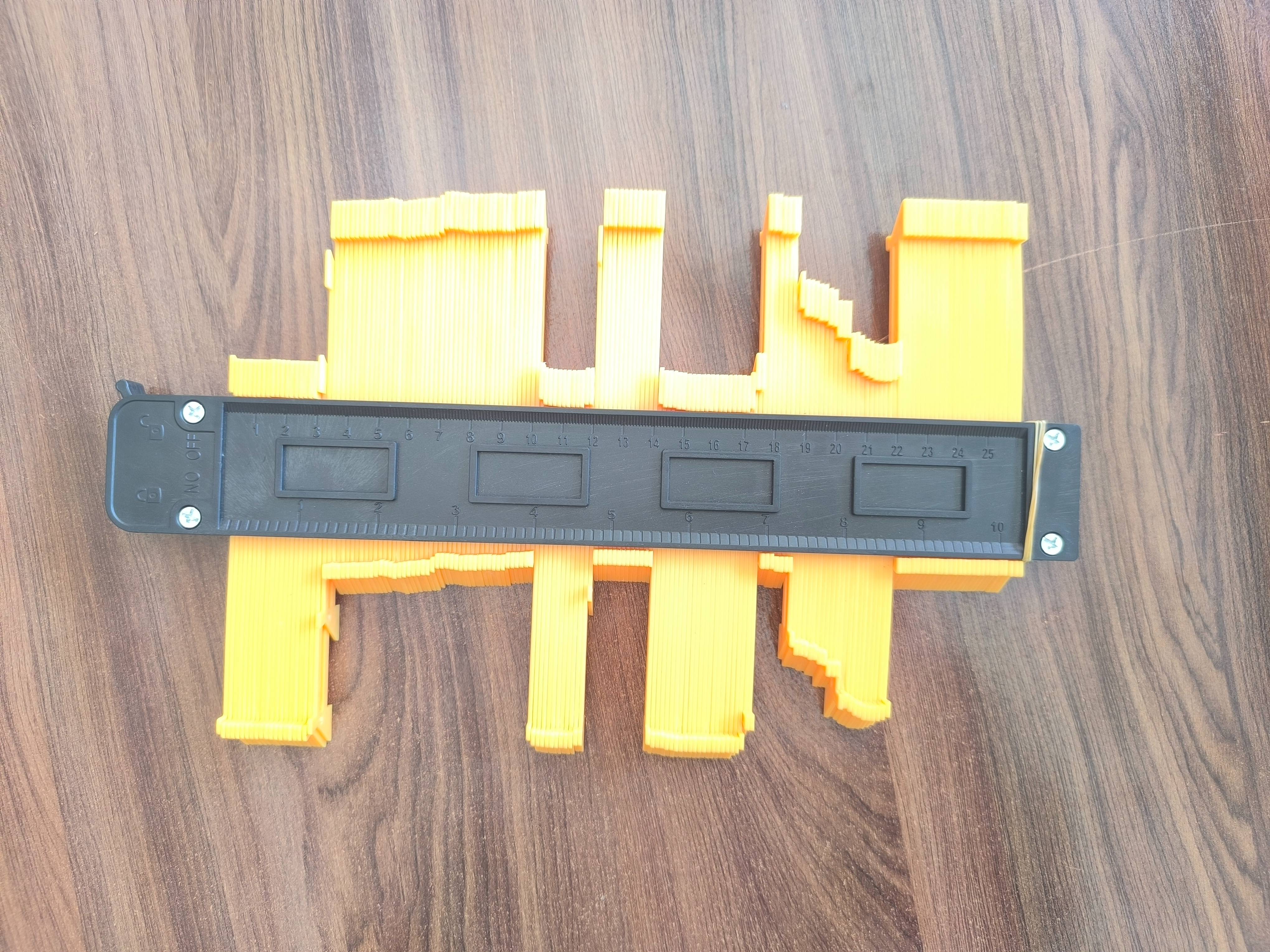 Contour Gauge Duplicator showcasing its adjustable arms and measurement markings, ideal for precise shape replication in Dhol