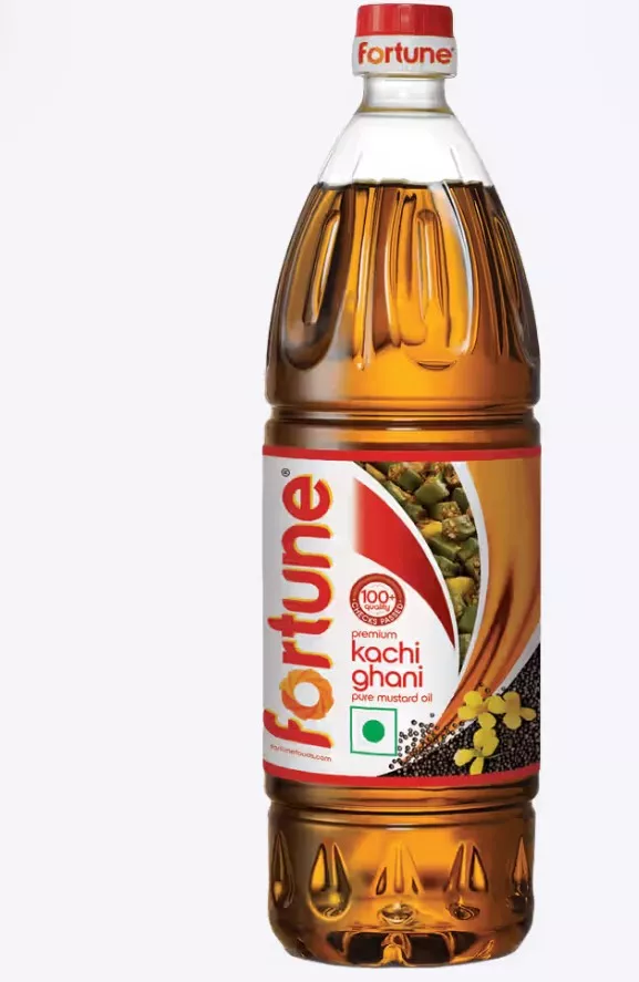 Fortune Kachi Ghani Pure Mustard Oil bottle on a kitchen countertop in Dommasandra, showcasing its rich color and packaging.