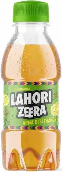 Rich cumin flavored Indian spiced drink Lahori Zeera from KAPIL DEV in MIANI KHAS, served in a glass with spices in the backg