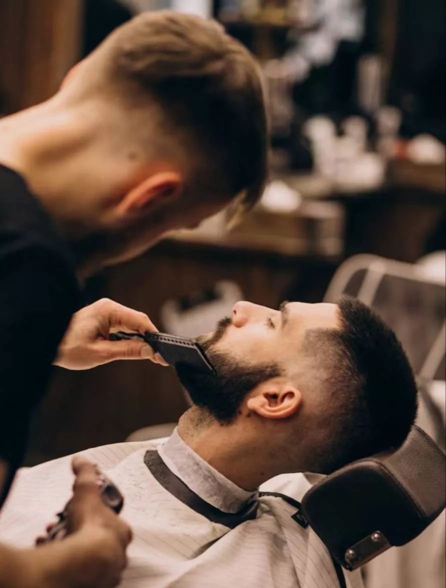 Hair cutting service provided by expert stylists at HARMAN NERHE HAIR SALON in Yamuna Nagar, showcasing a modern salon enviro