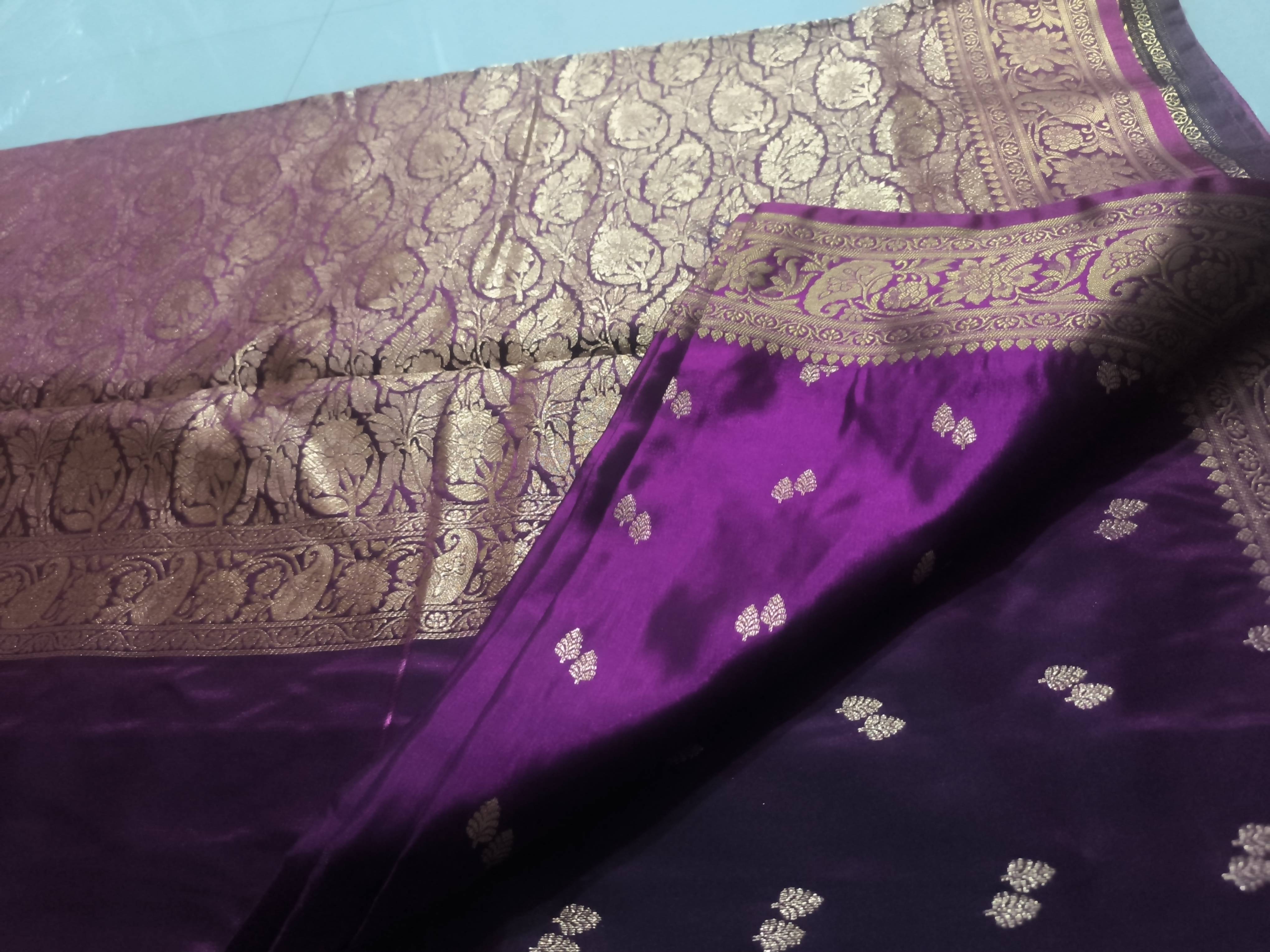 Elegant Banarashi saree with intricate zari weaving displayed in Pune, showcasing luxurious satin fabric and traditional desi