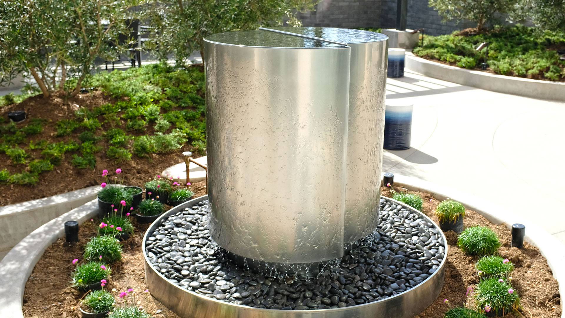 Dynamic stainless steel Sage Water Sculpture with flowing water, enhancing a modern space in New Delhi.