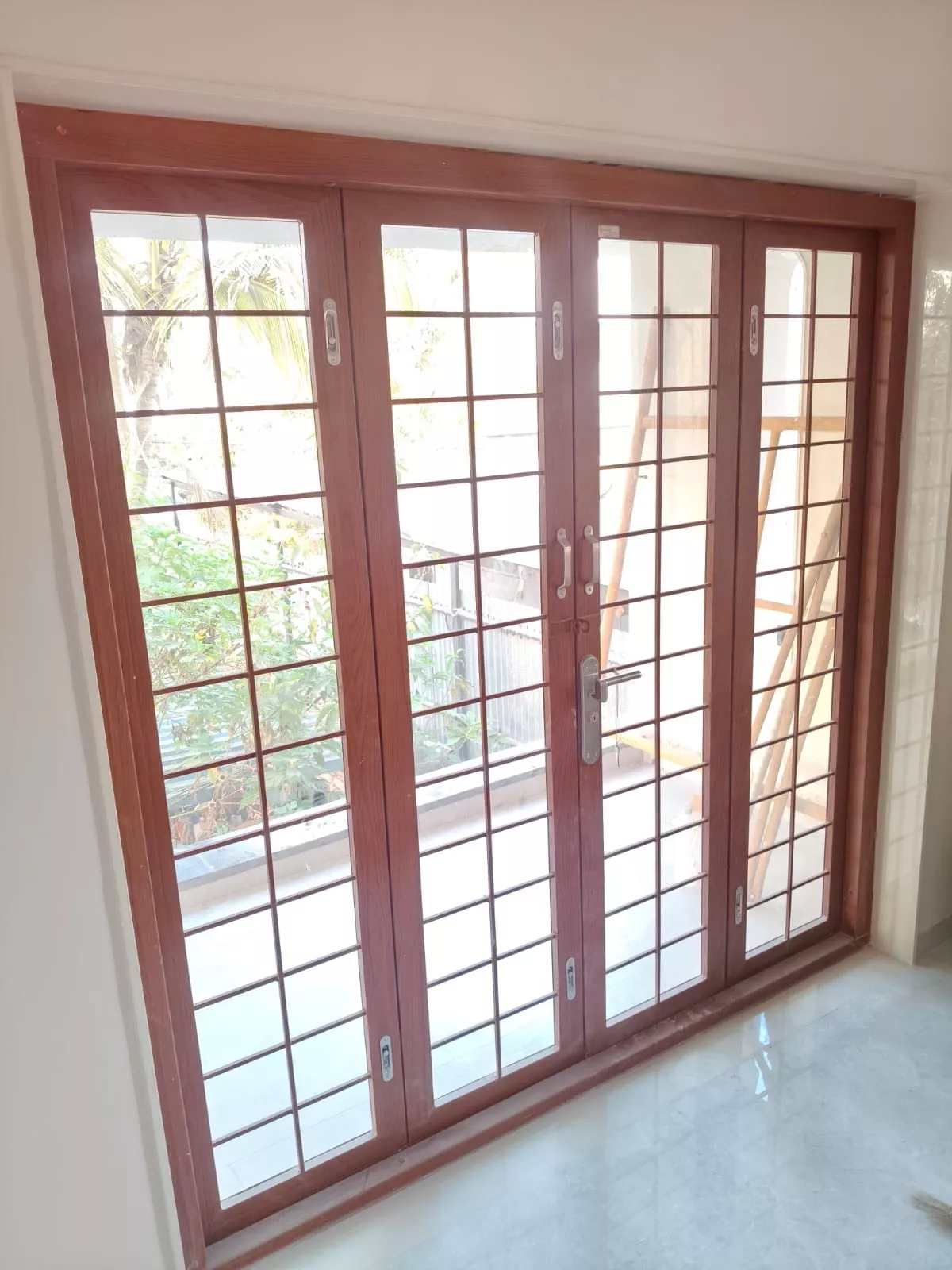Stylish Wooden Sliding French Door with grid design showcasing elegant craftsmanship in Achalpur