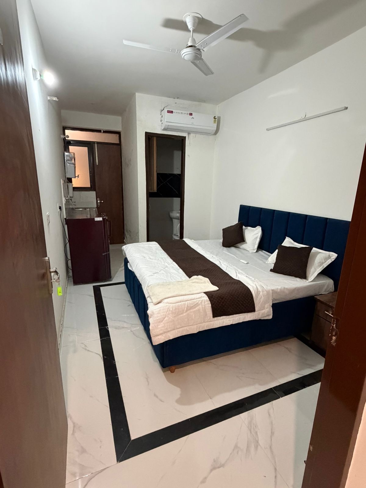 Fully furnished studio apartment featuring air conditioning, modern decor, and spacious layout in Zirakpur, Banur.