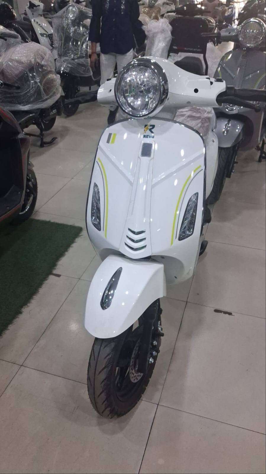 Modern electric scooter Revo Vespa with remote central locking keys, showcasing sleek design and features in Sirhind.