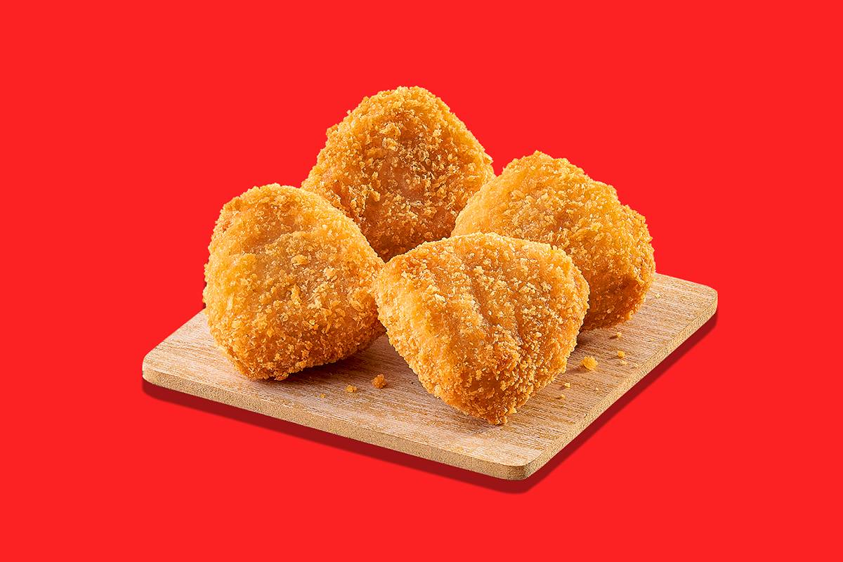 Crispy 12pies Chicken Nuggets served on a plate with a dipping sauce in Hyderabad.