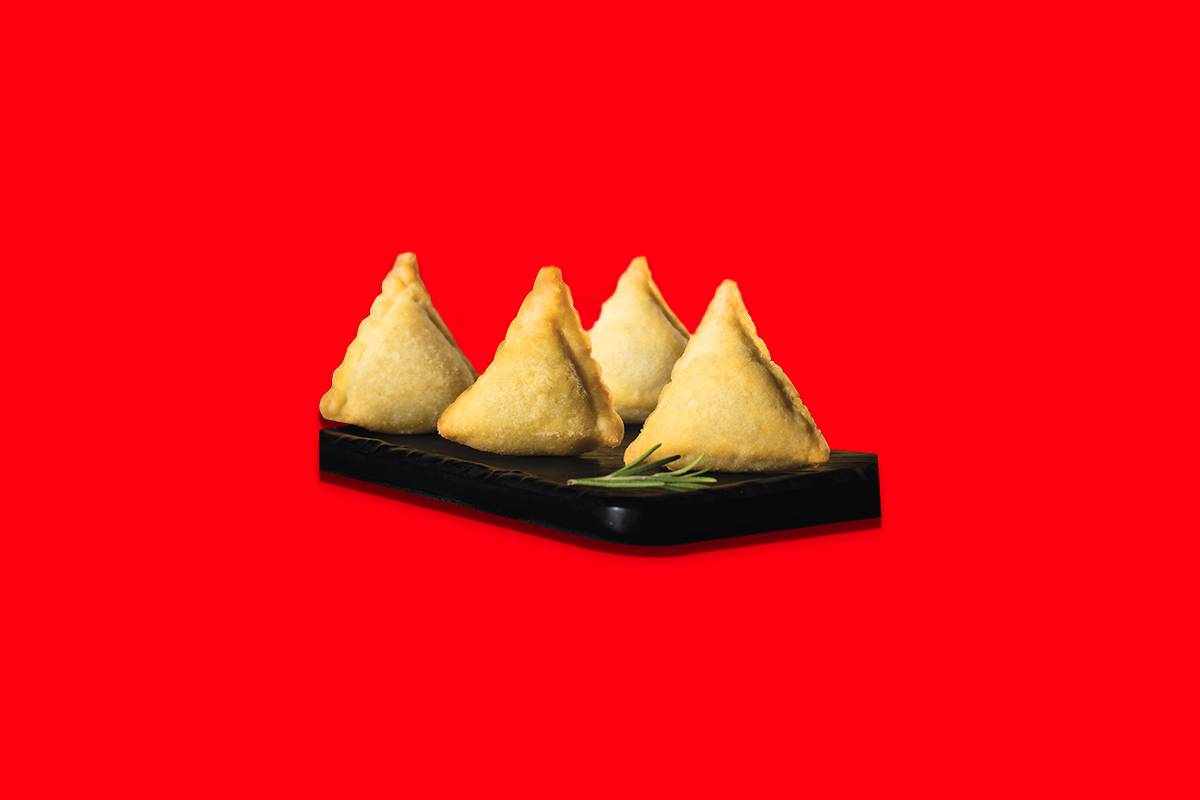Crispy mini veg samosas from FIVE STAR CHICKEN in Hyderabad, served hot and golden brown, perfect for snacking.