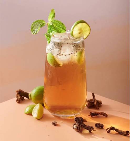 Chilled Nannari/Sugandha Sharabat with mint, lemon slices, and basil seeds in Hyderabad, served in a clear glass. - Image 1