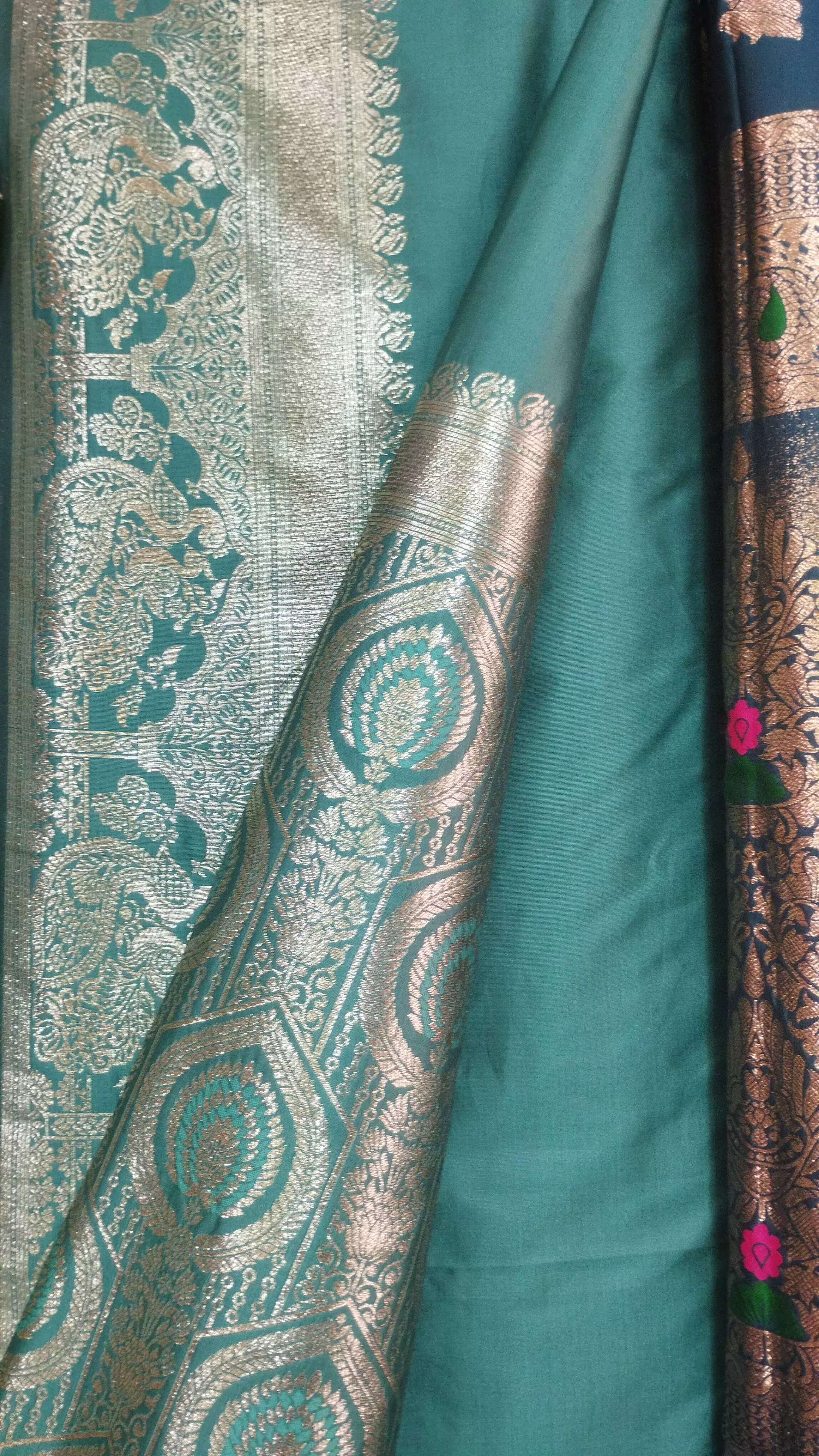 Elegant teal silk brocade saree with intricate silver zari motifs, ideal for festive wear, showcased in GORAKHPURMP.