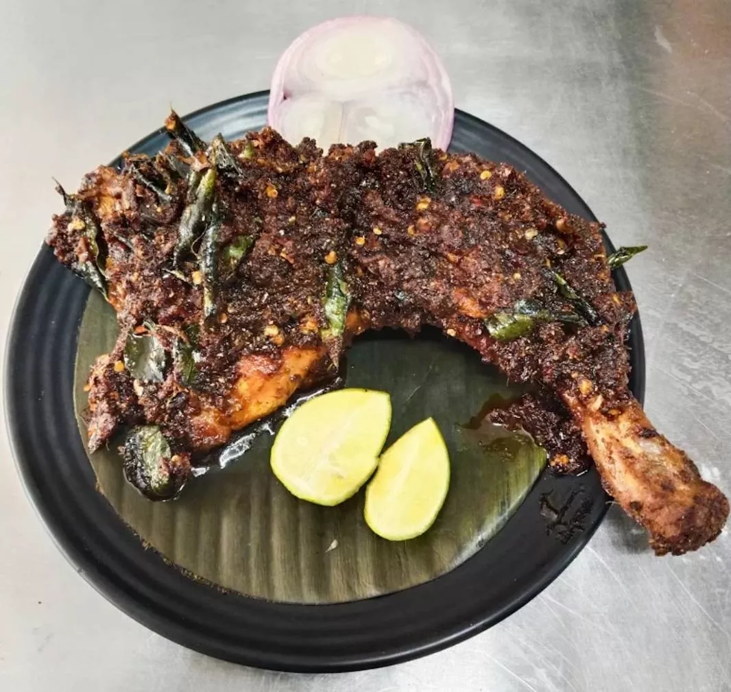 Spicy Snack Gun Fire Chicken served with a vibrant red chili garnish, showcasing its fiery look and appetizing presentation i