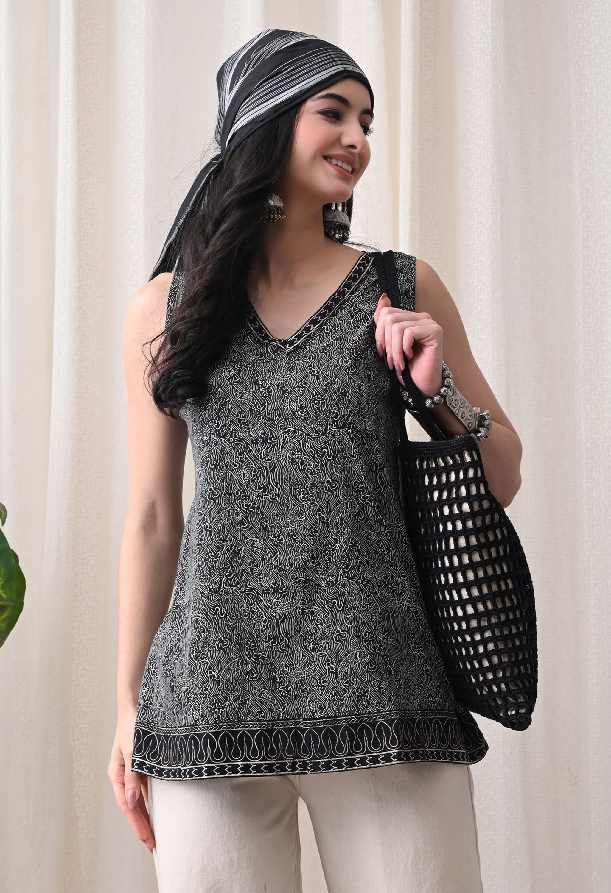 Stylish black sleeveless top with a tie-up neck design from CLICK KART in Jaipur, perfect for summer fashion. - Image 1