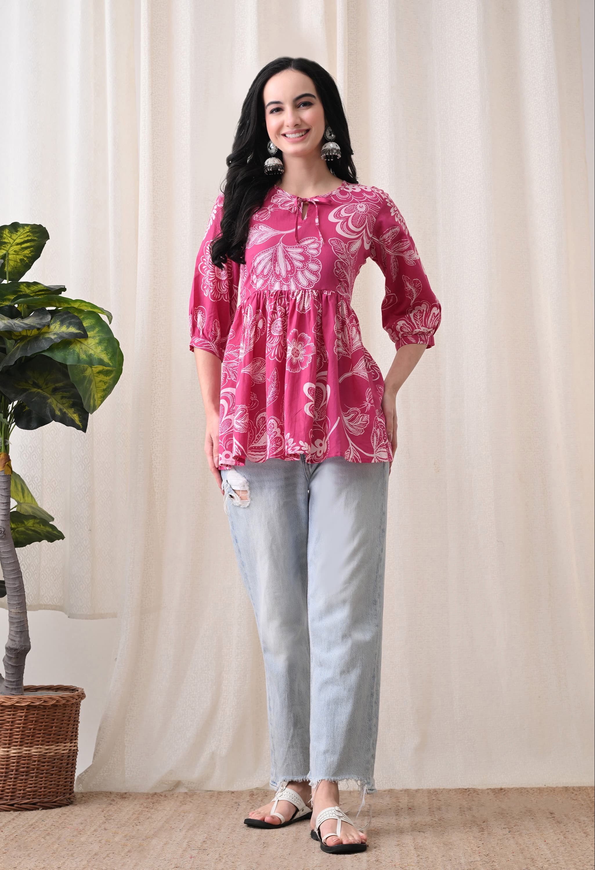 Vibrant pink floral cotton peplum top hanging on display in Jaipur, showcasing its elegant design and breathable fabric. - Image 2