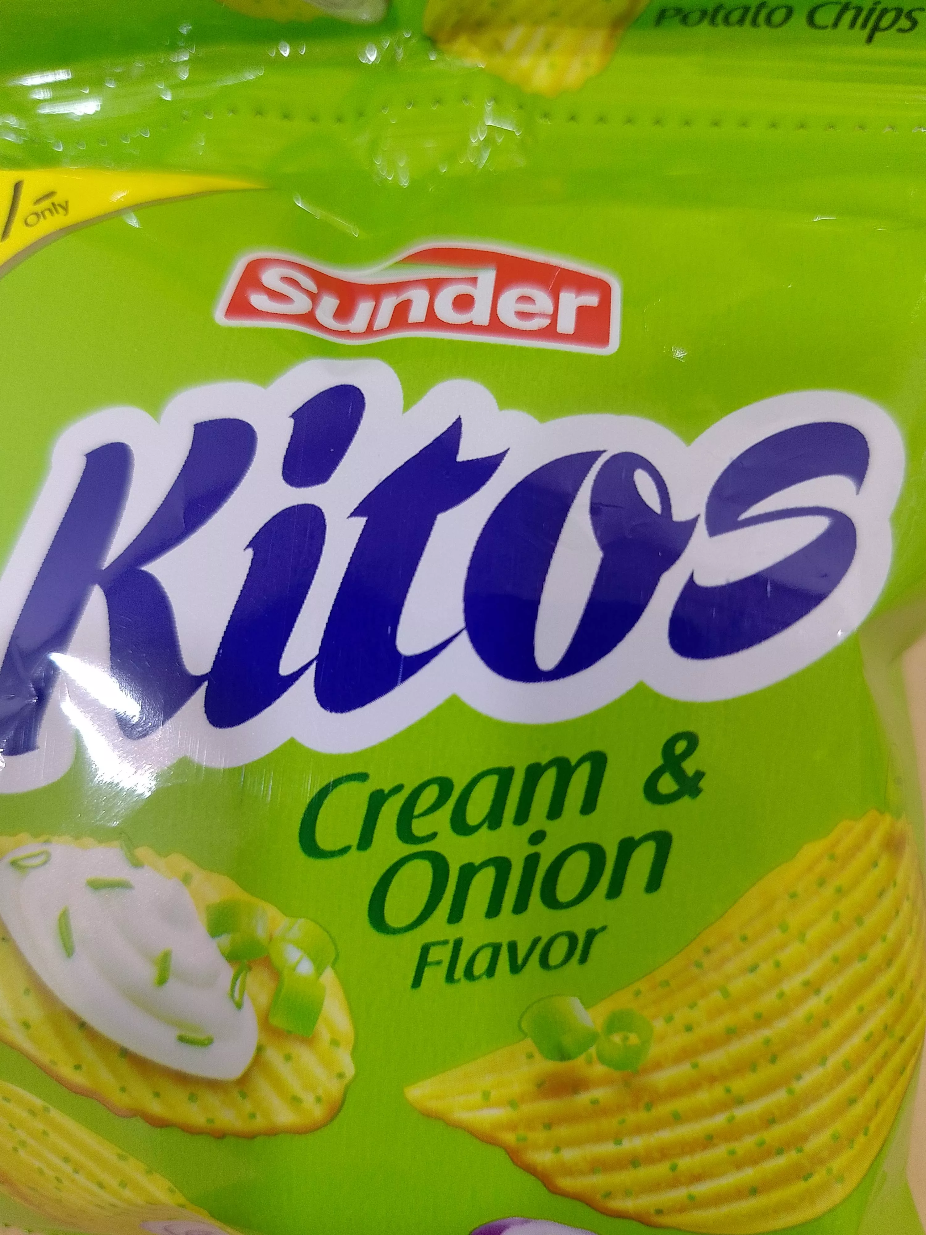 Kitos Potato Chips in a vibrant package showcasing cream and onion flavor, displayed at KUSHWAHA GENERAL STORE in Tilda.