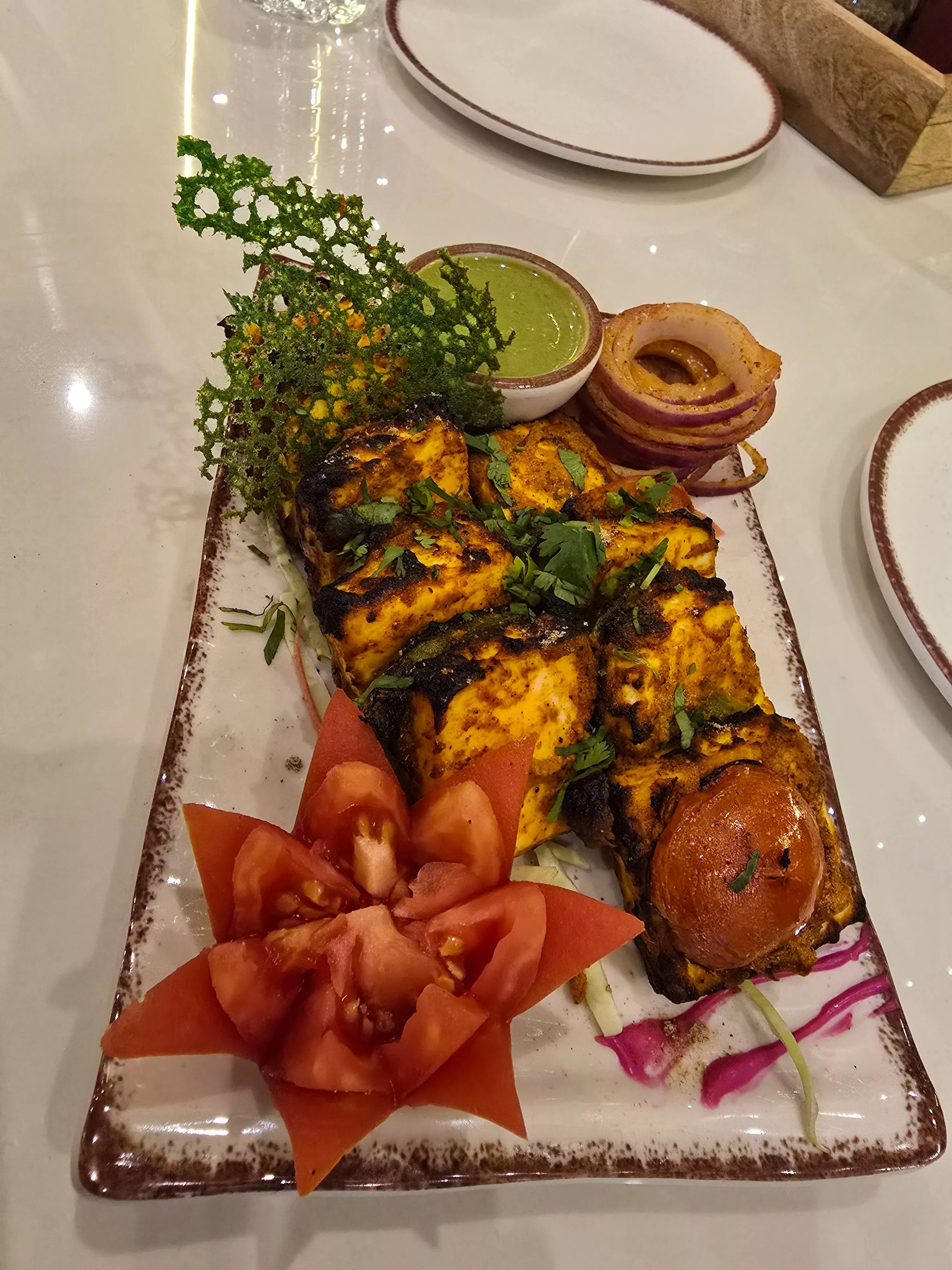 Delicious grilled paneer cubes marinated in spices, served at THE FORTRESS CAFE in DUDU, showcasing authentic Indian cuisine.