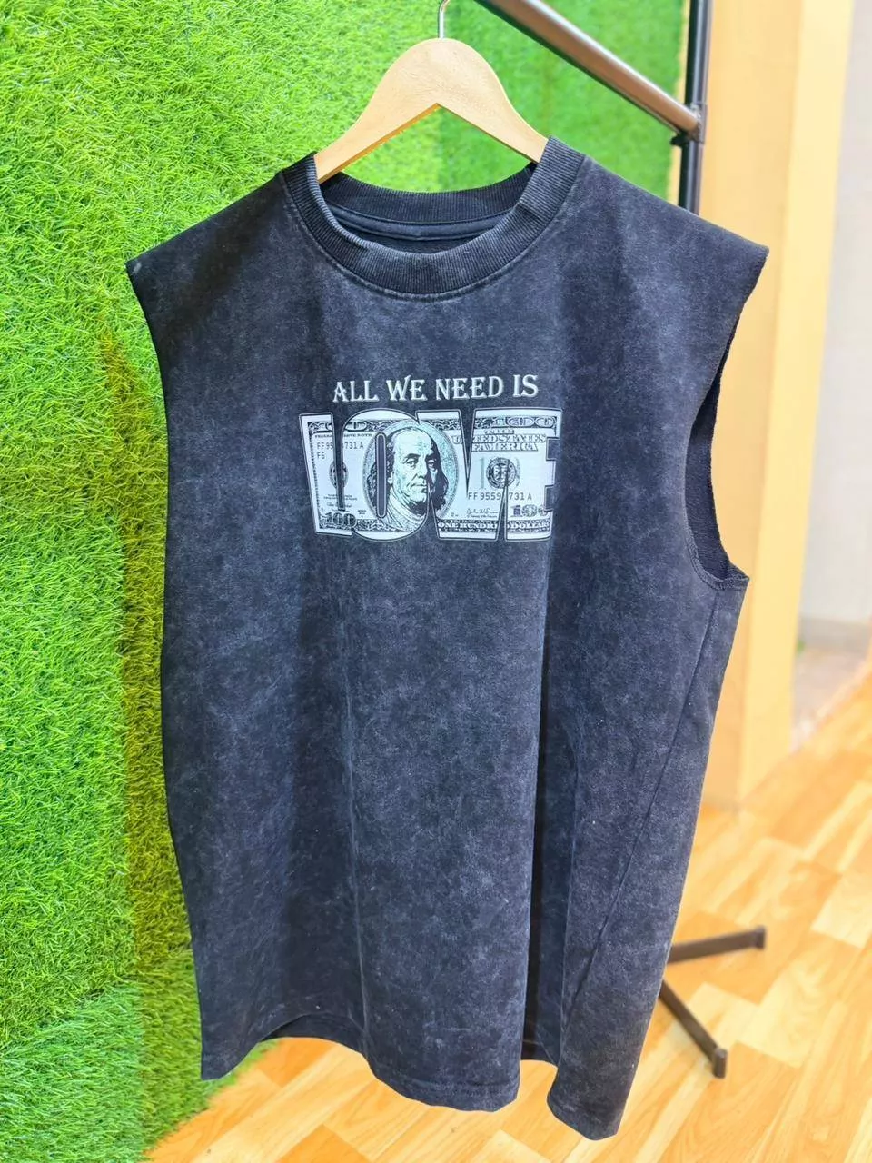 Black sleeveless T-shirt featuring 'All We Need Is Love' graphic from SHIVAM ENTERPRISE, KOLKATTA, suitable for casual wear.
