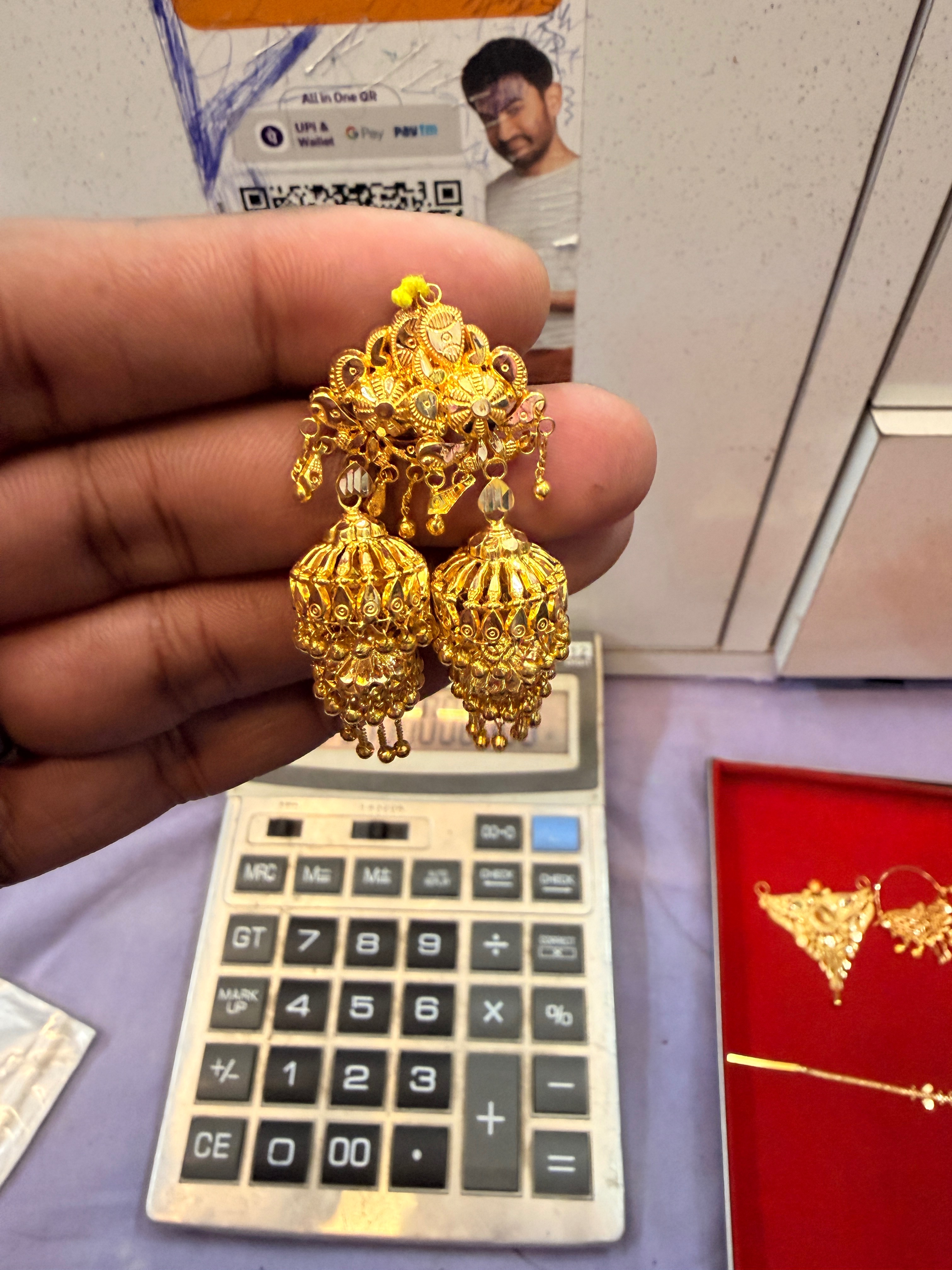 Elegant 18k jhumka earrings designed at Shubham Jewellers in Akbarpur, showcasing intricate craftsmanship and stunning detail