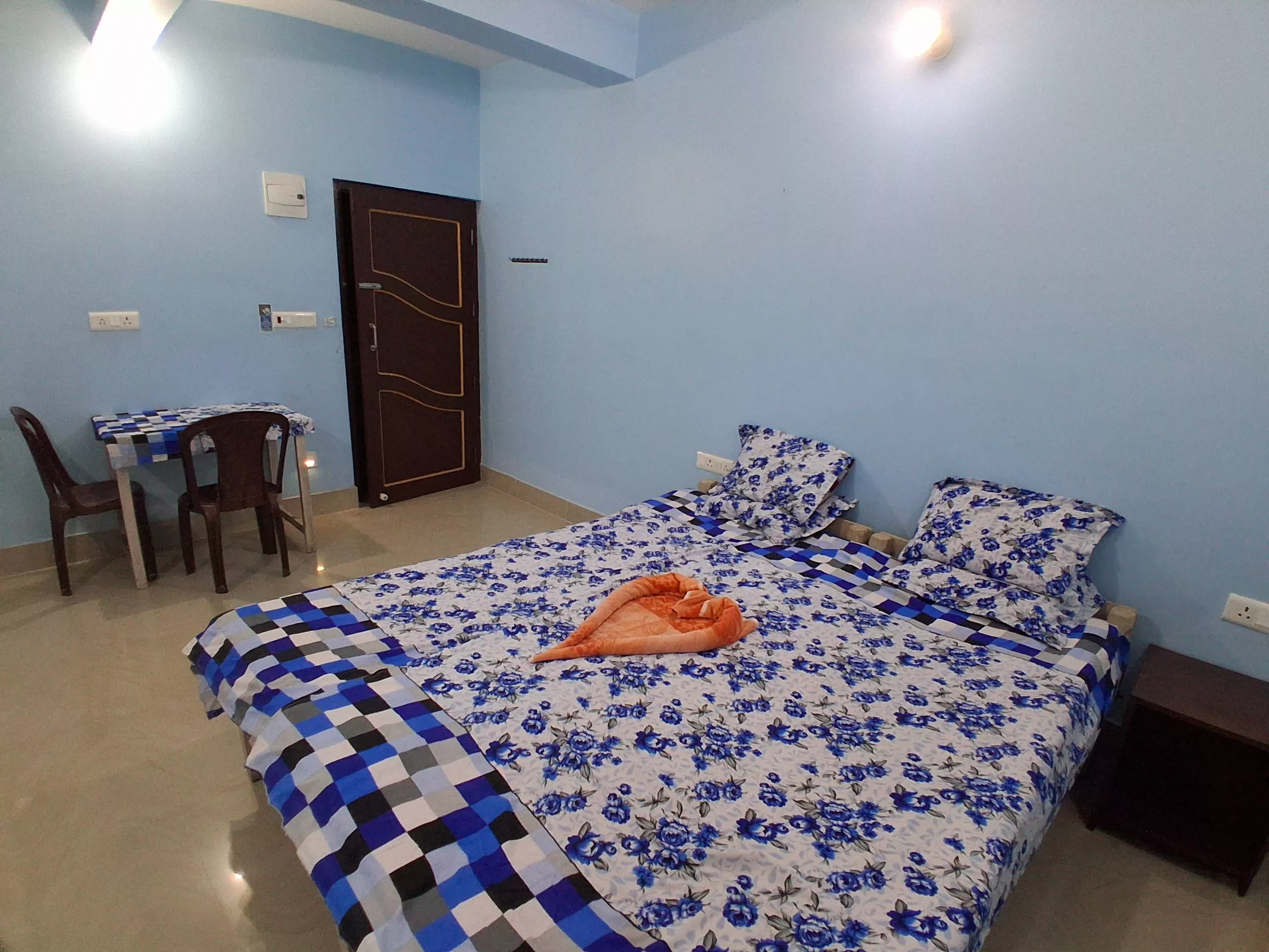 Elegant double bed room with blue floral bedsheet set in NABADWIP, designed for 2 adults and 1 child, featuring an attached b - Image 3