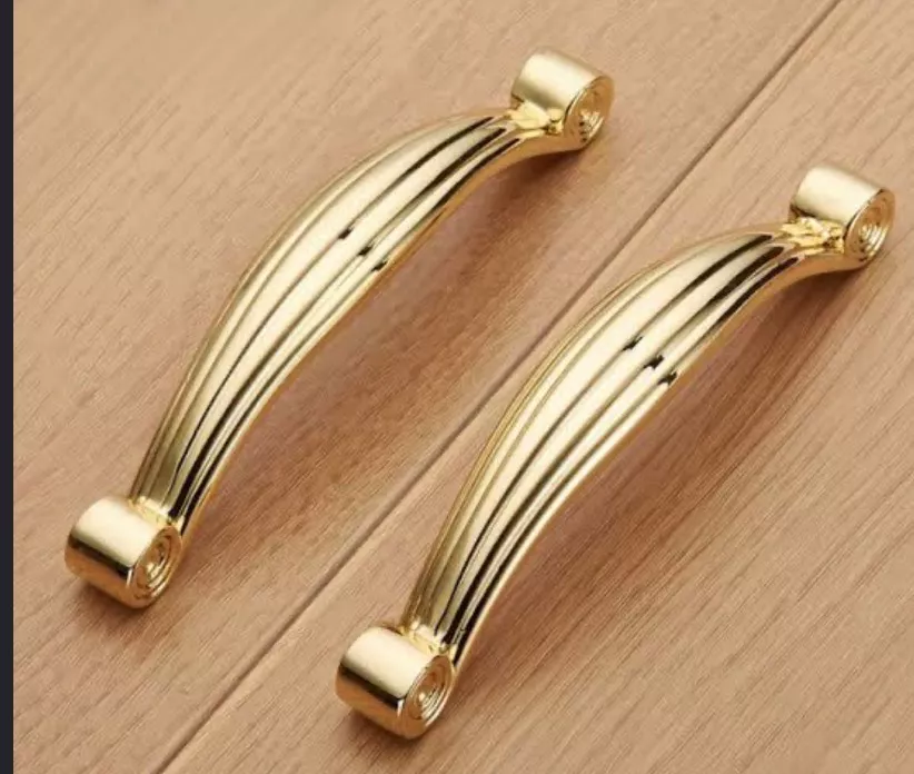 Stylish gold-plated cabinet handles designed for elegant interiors, featuring intricate detailing, available at K H ENTERPRIS