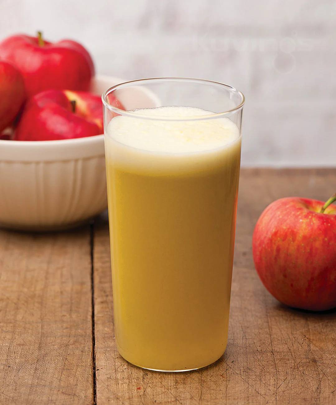 Delicious, freshly made Apple Juice in Dharwad served in a clear glass, showcasing its vibrant color and fresh apple slices g