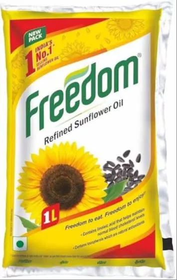 Bottle of Freedom Refined Sunflower Oil with a golden hue, showcasing the label and product details, set against a kitchen ba