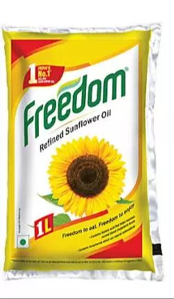 Bottle of Freedom Refined Sunflower Oil with a golden hue, showcasing the label and product details, set against a kitchen ba - Image 1