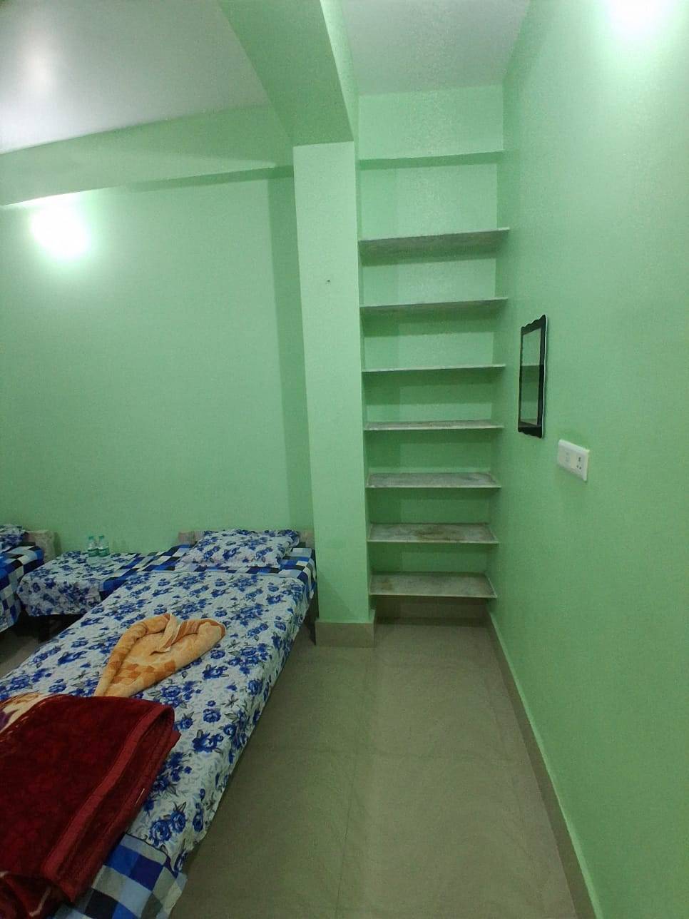 AC room at BHAKTA BHAWAN in NABADWIP featuring a comfortable bed, balcony access, and modern amenities for a pleasant stay. - Image 1