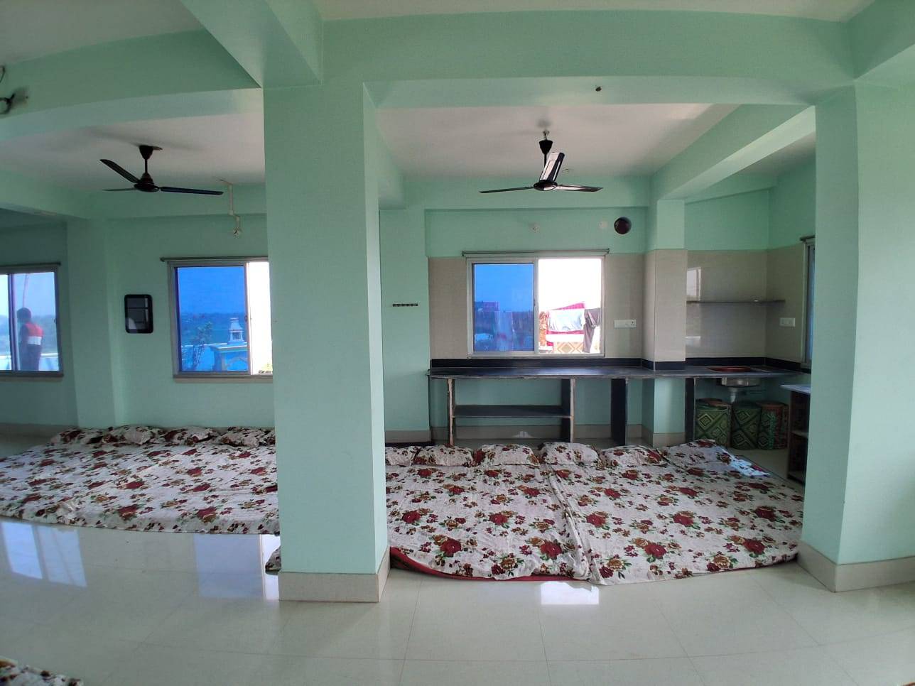 Spacious 20-Person Dormitory Room in Nabadwip with floor mattresses and modern amenities for group stays.