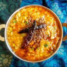 Delicious Dal Tadka served in a bowl with aromatic spices, garnished with coriander, from Dakhhan Restaurant TARALA