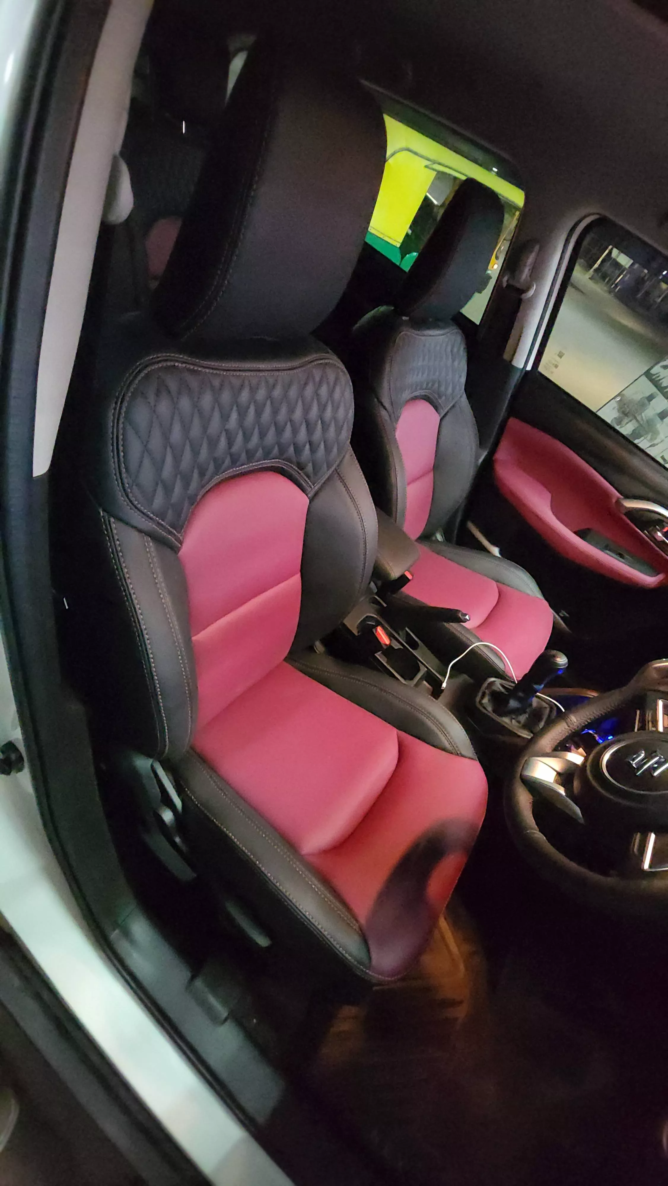 Premium black and red car seat covers designed for style and comfort, displayed in a vehicle interior in Bangalore.