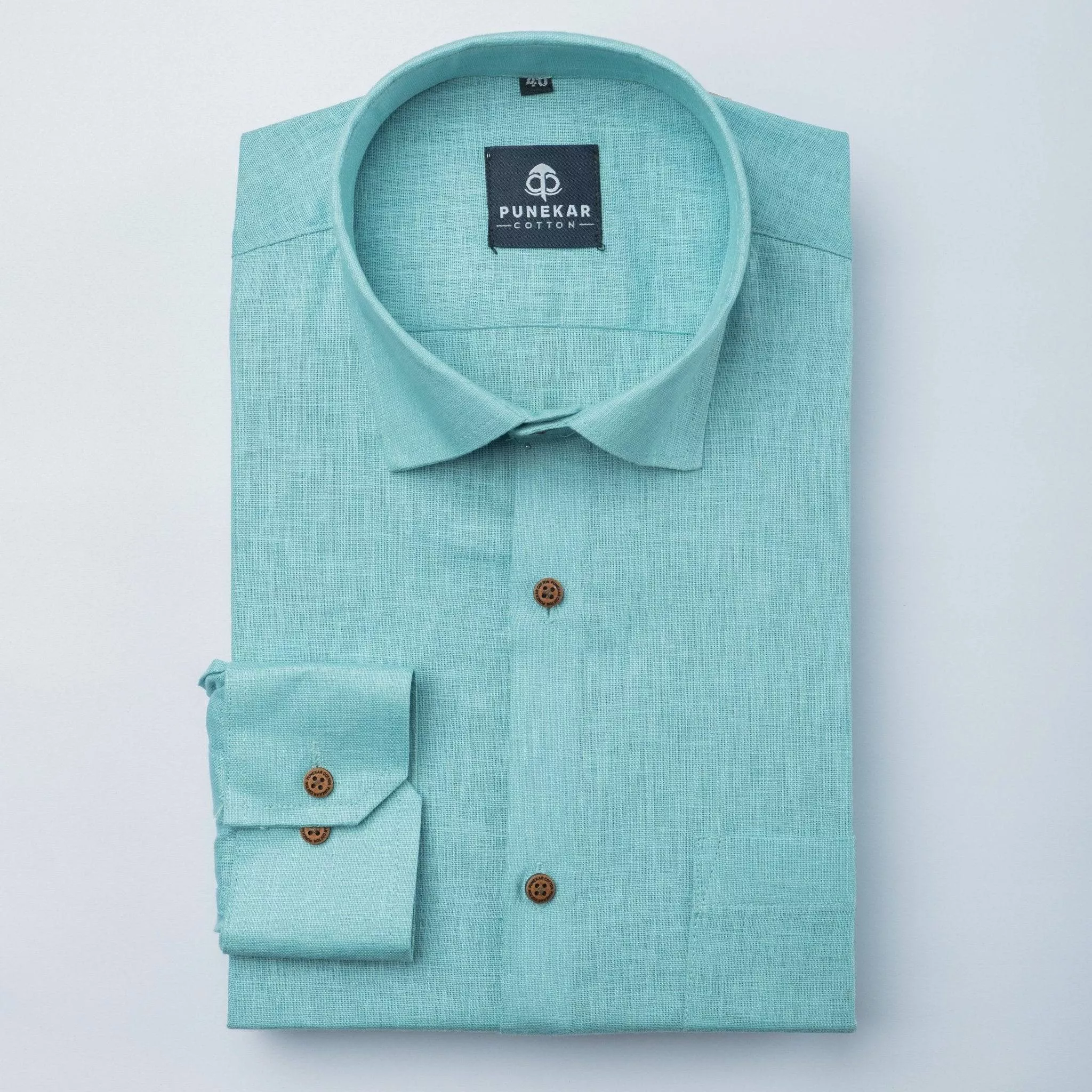 Stylish teal Punekar Cotton Men's Shirt displayed in a retail setting in Anantapur, showcasing its elegant design and fabric 