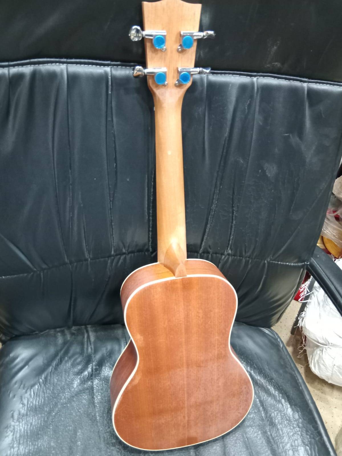 Compact and lightweight Ukulele Guitar made from high-quality wood, featuring a melodious sound, available at MELODY MAKERS I - Image 3