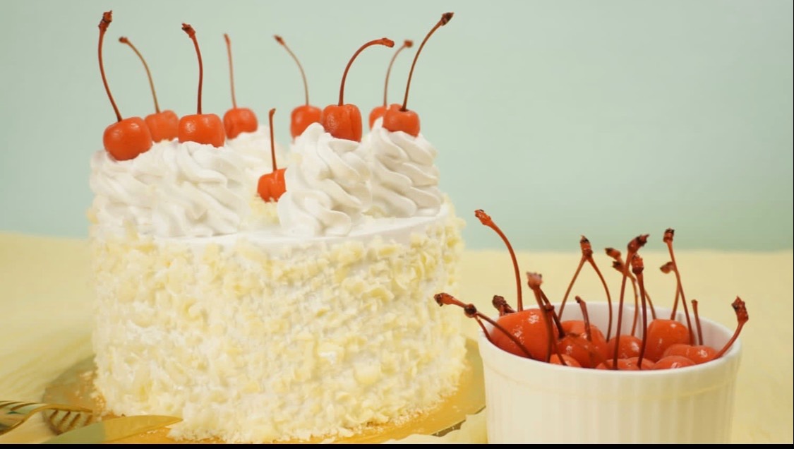 Delicious White Forest Luxe Cake in Bangalore topped with cherries and whipped cream, showcasing its elegant design and rich 